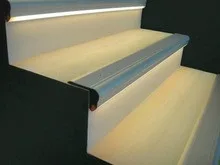 Warm white LED strip installed inside aluminium stair nosing profile on staircase step