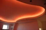 Red RGB LED strip lighting installed in curved ceiling bulkhead for decorative lighting effect